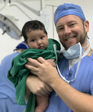 Dr. Brown with child post-surgery